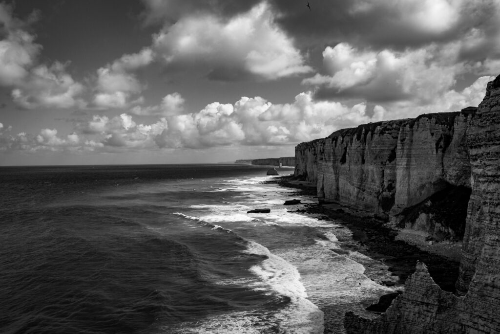 Dramatic Black and White Seascape Wallpaper with Rugged Cliffs