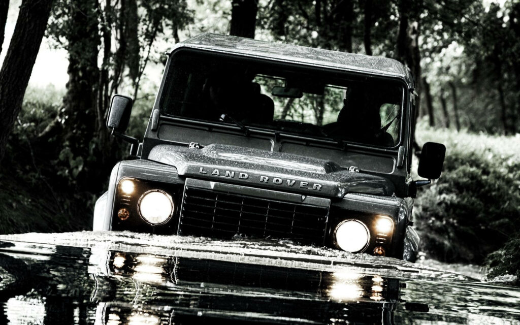 Adventure Awaits: Black-and-White Land Rover Wallpaper Background