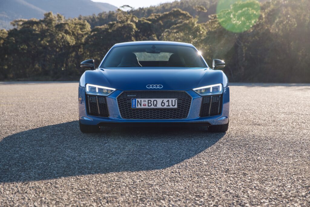 Elegant Blue Audi R8 V10 on Serene Open Road - Stunning Wallpaper