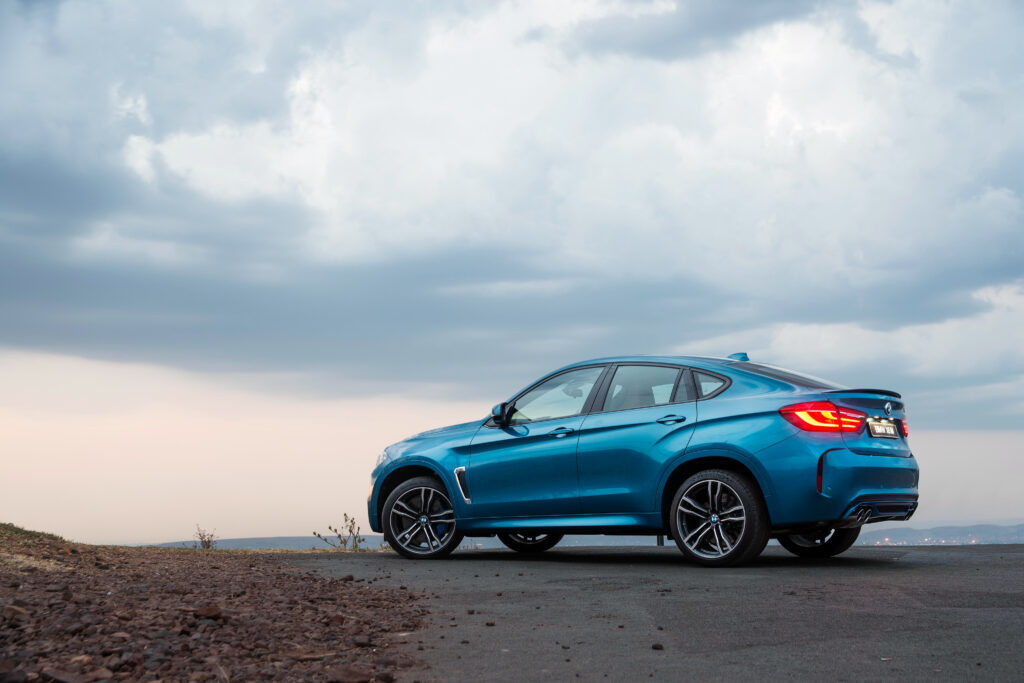 Blue BMW X6 F16 - Stunning Side View with Scenic Outdoor Background Wallpaper