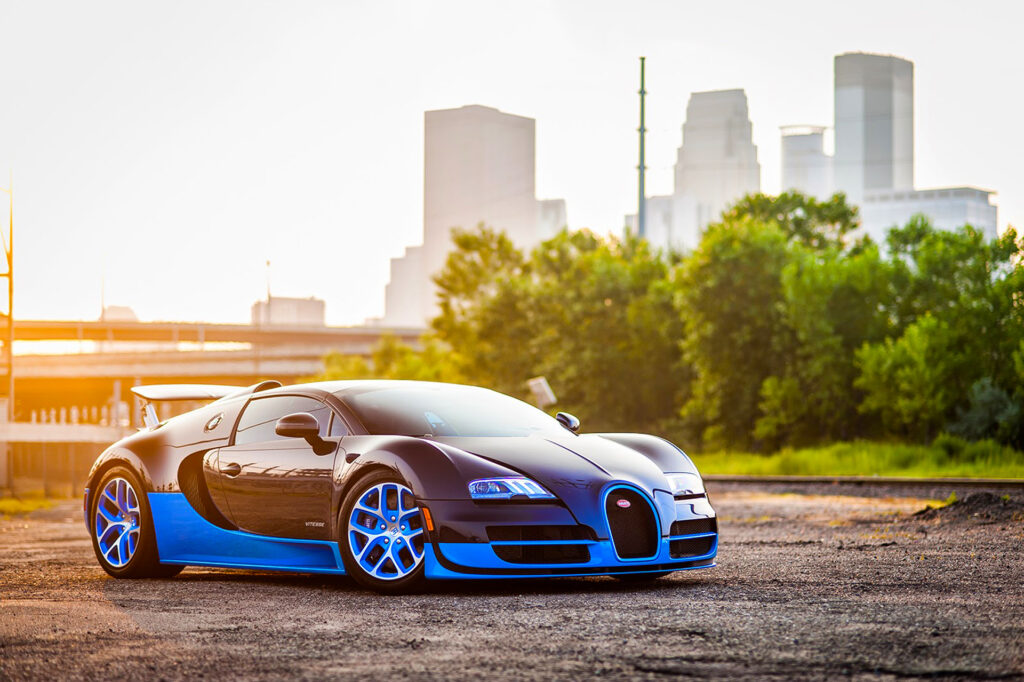 Stunning Blue Bugatti Veyron Against Urban Skyline Wallpaper