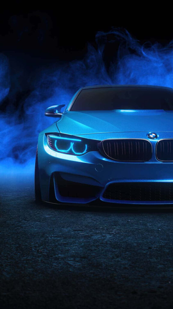 Sleek blue car with glowing headlights and dramatic reflections on dark smoky background wallpaper