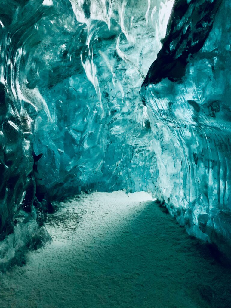 Icy cave wallpaper with detailed blue teal ice formations and smooth frozen textured walls