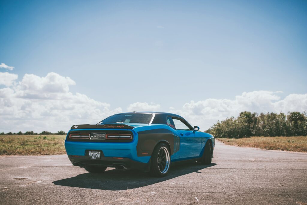 Stunning Blue Sports Car Wallpaper: Sleek Design on Open Road