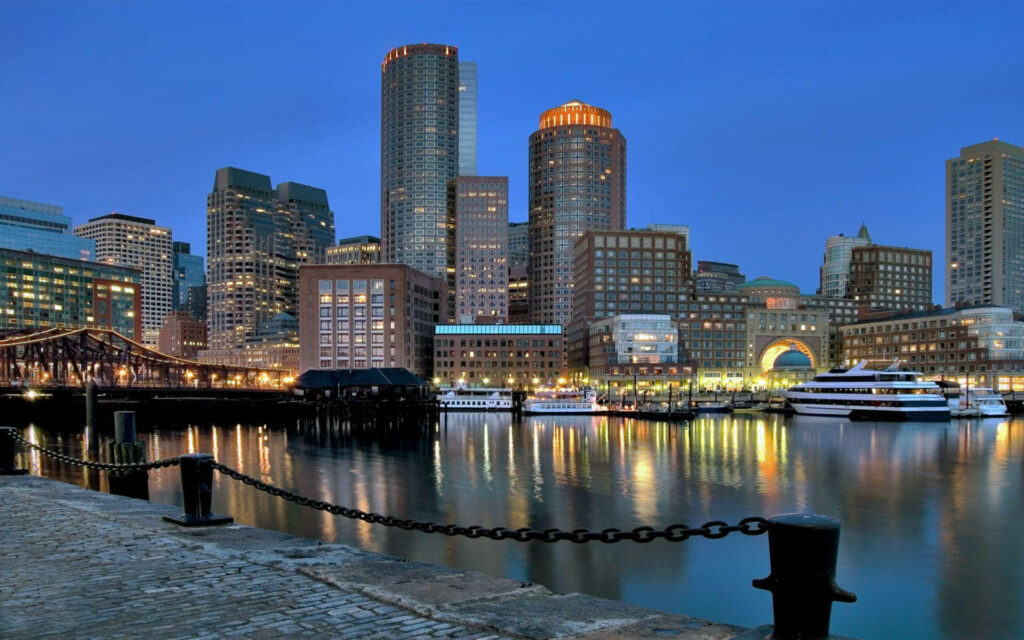 Boston Harbor Evening Skyline: Illuminated Waterfront Wallpaper