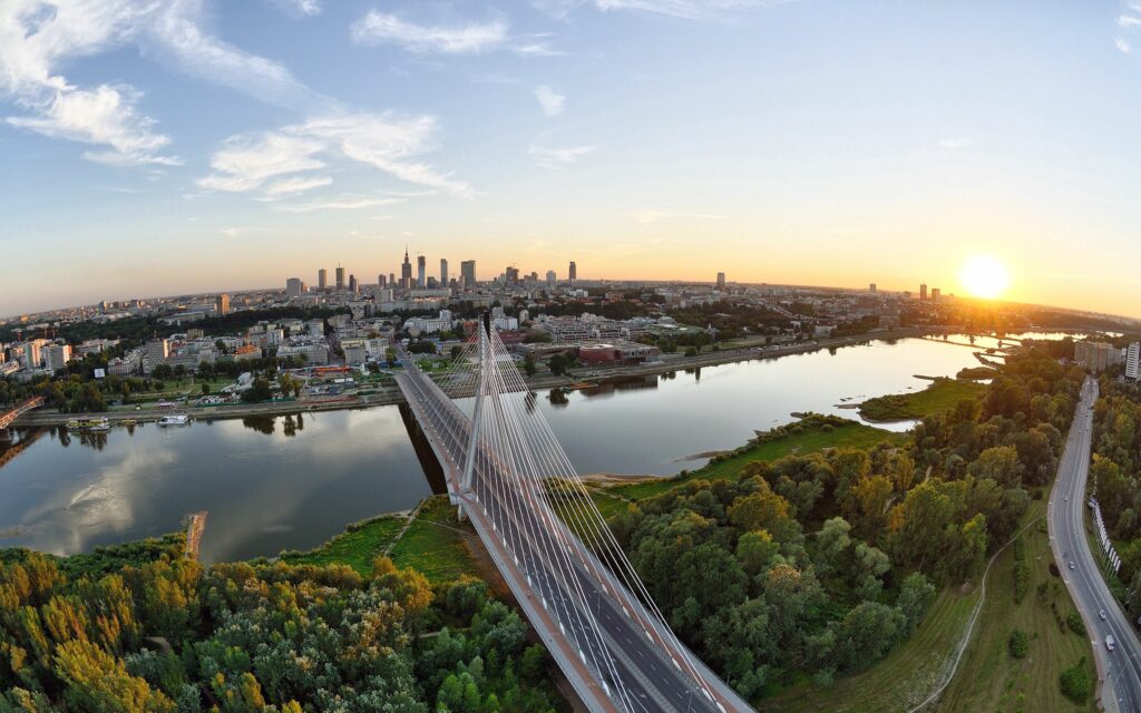 Stunning Bridge Wallpaper: Sunset Over Calm River & Lush Cityscape