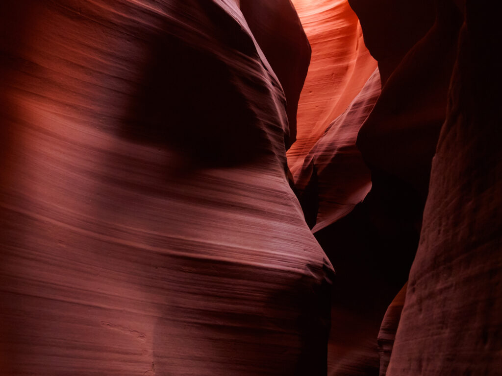 Stunning cave wallpaper with smooth layered brown rock formations and dramatic textured lighting