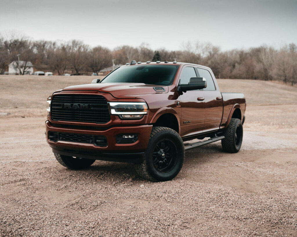 Rugged Brown RAM Truck Wallpaper: Power Meets Scenic Adventure