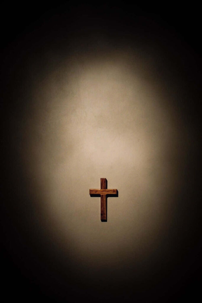 Elegant Brown Wooden Cross Wallpaper with Textured Vignette Background