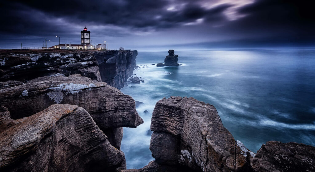 Cabo Carvoeiro Cliffs & Lighthouse: Dramatic Ocean View Wallpaper