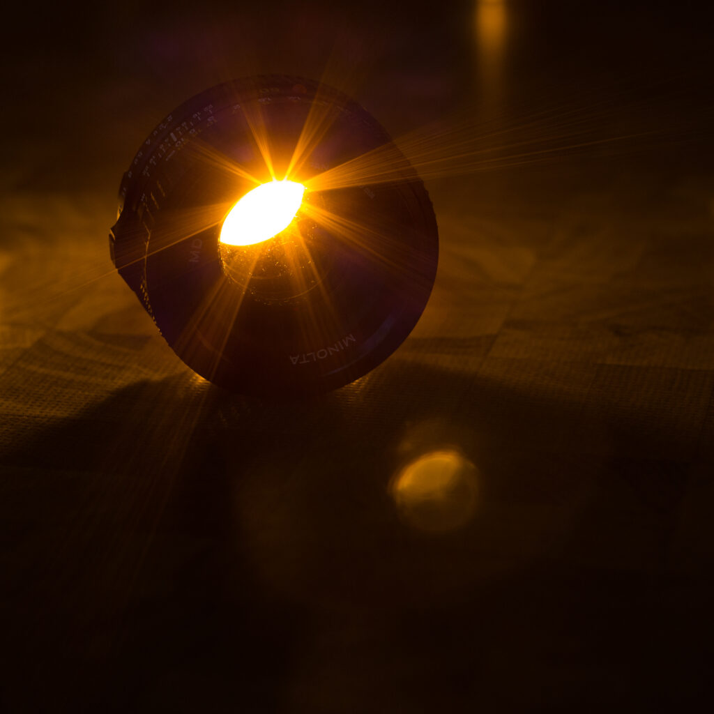 Stunning Camera Lens Wallpaper: Golden Light & Artistic Shadows