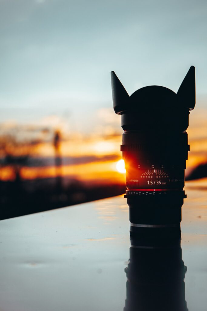 Stunning Camera Lens Wallpaper Under Ethereal Sunset Glow