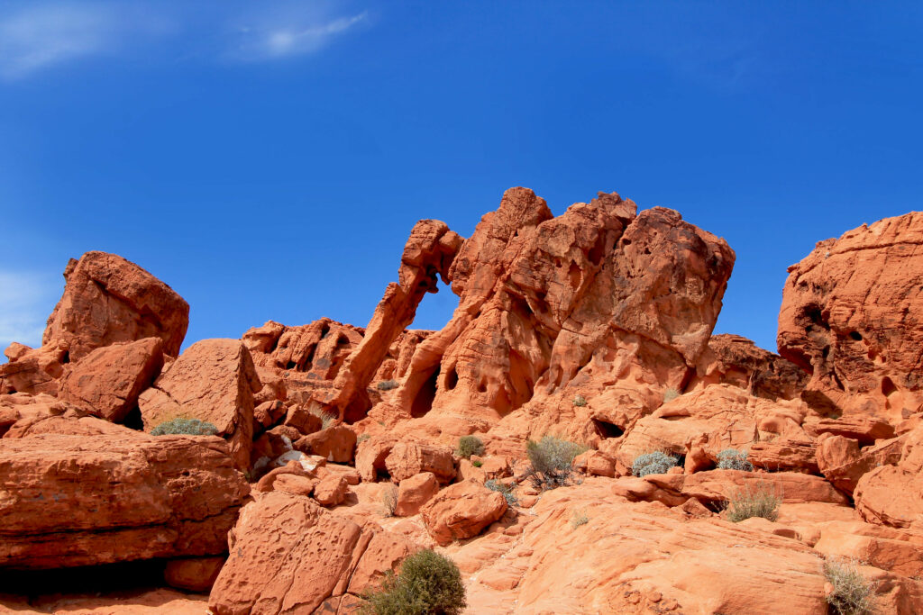 Stunning canyon landscape with rugged orange rocks sandy terrain and bright blue sky wallpaper