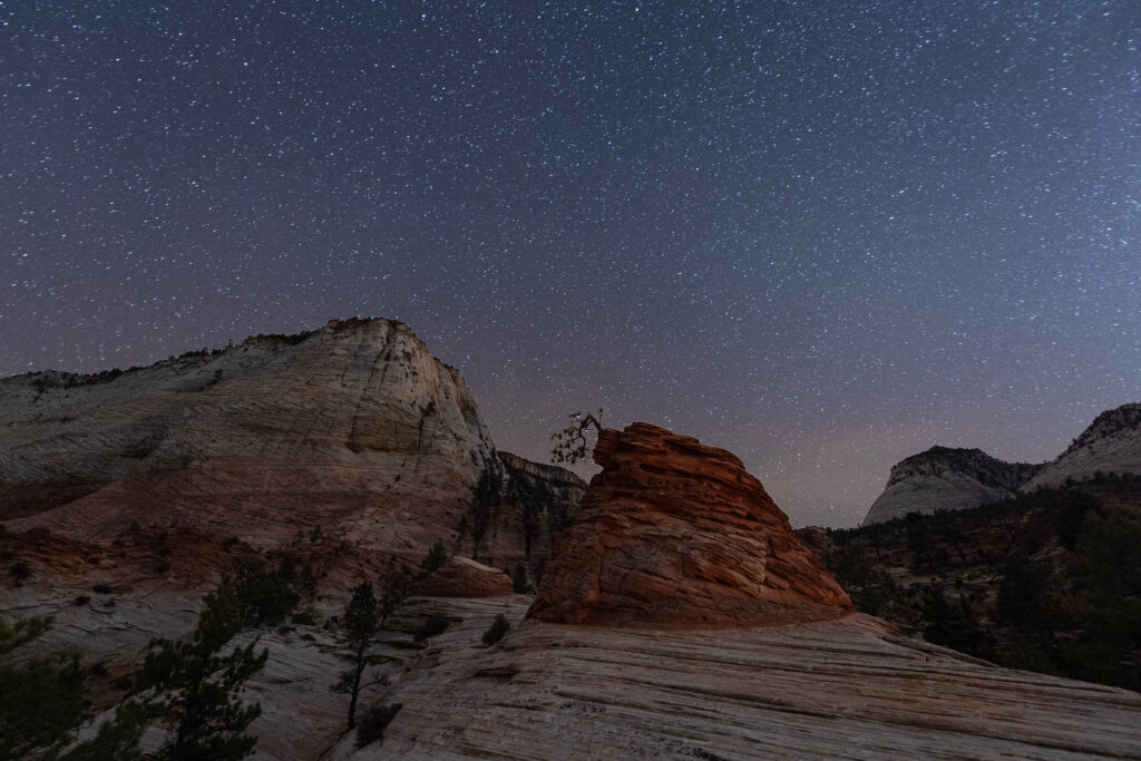 Stunning canyon rocks under a starry night sky with deep blues and earthy tones wallpaper