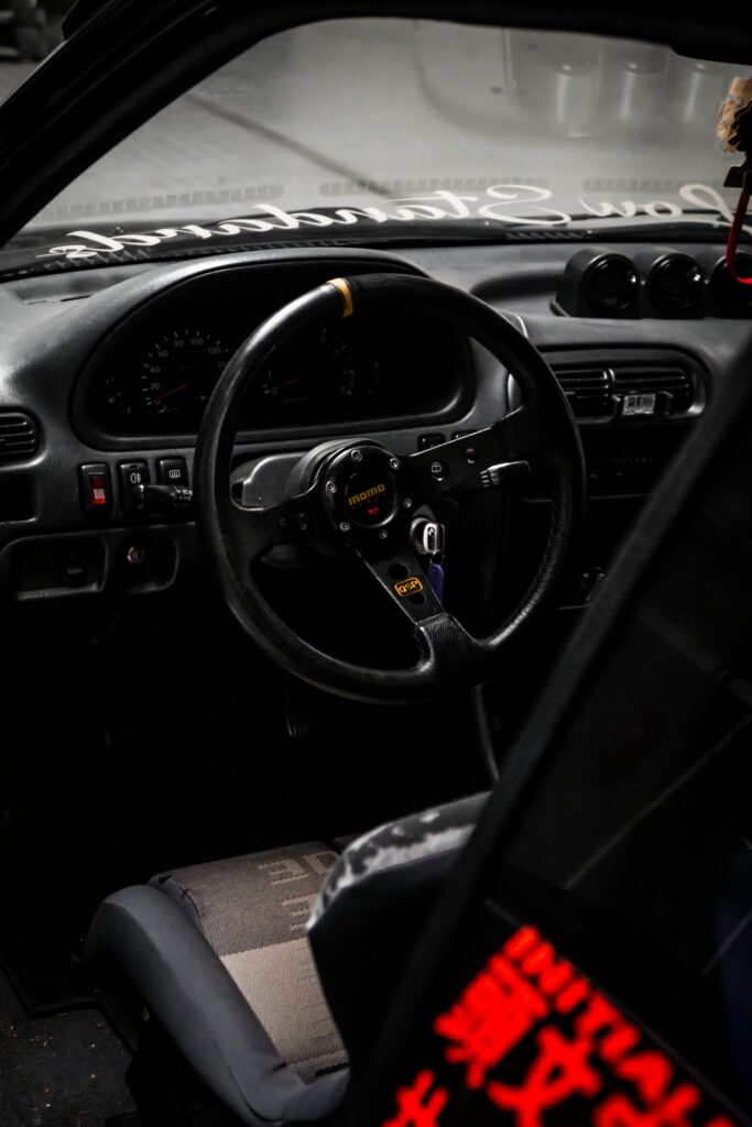 Stylish Car Interior Wallpaper: Momo Steering Wheel & Classic Dashboard