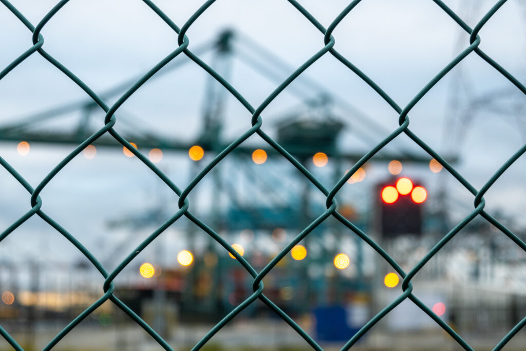 Artistic Chain-Link Fence Wallpaper with Bokeh Industrial Glow