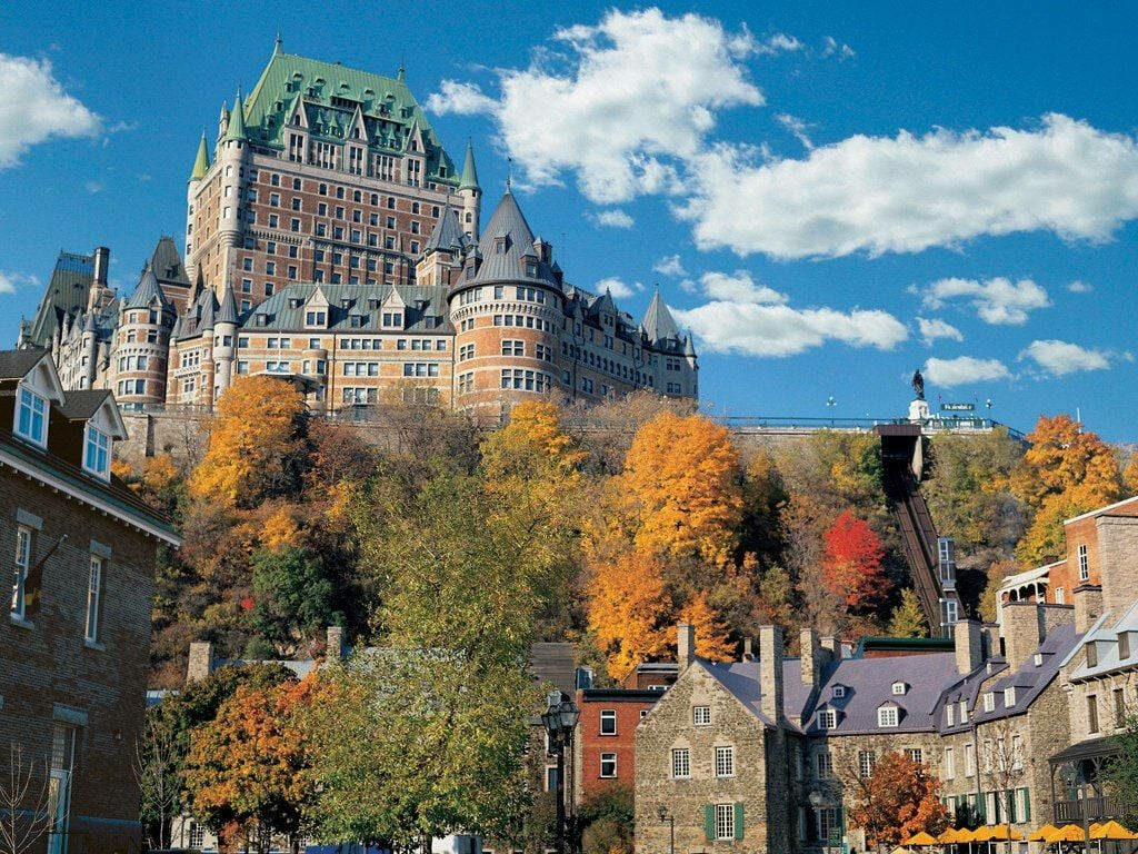 Autumn Wallpaper: Iconic Château Frontenac in Quebec Under Blue Sky
