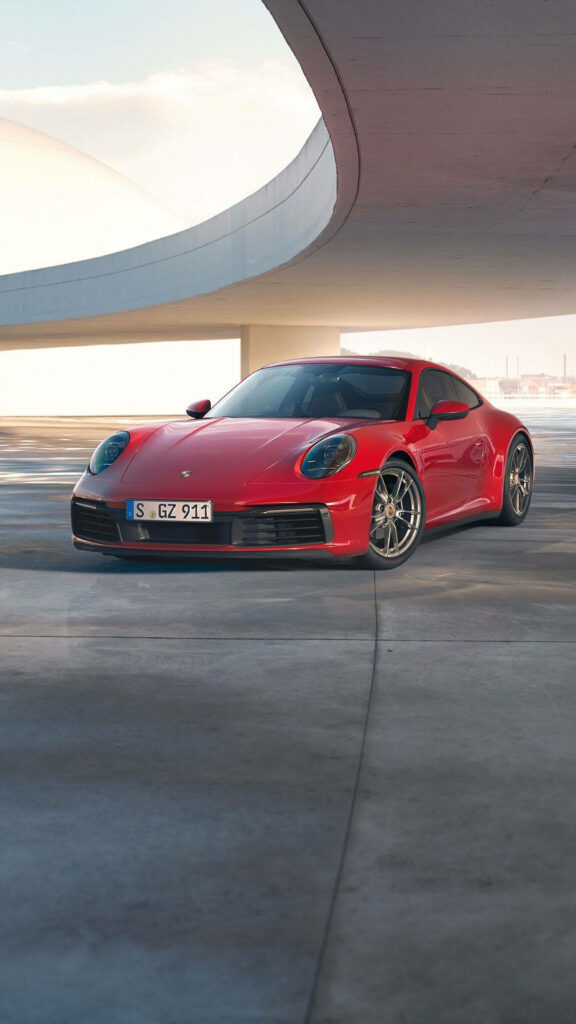 Elegant Cherry-Red Porsche 911 Wallpaper with Modern Architecture