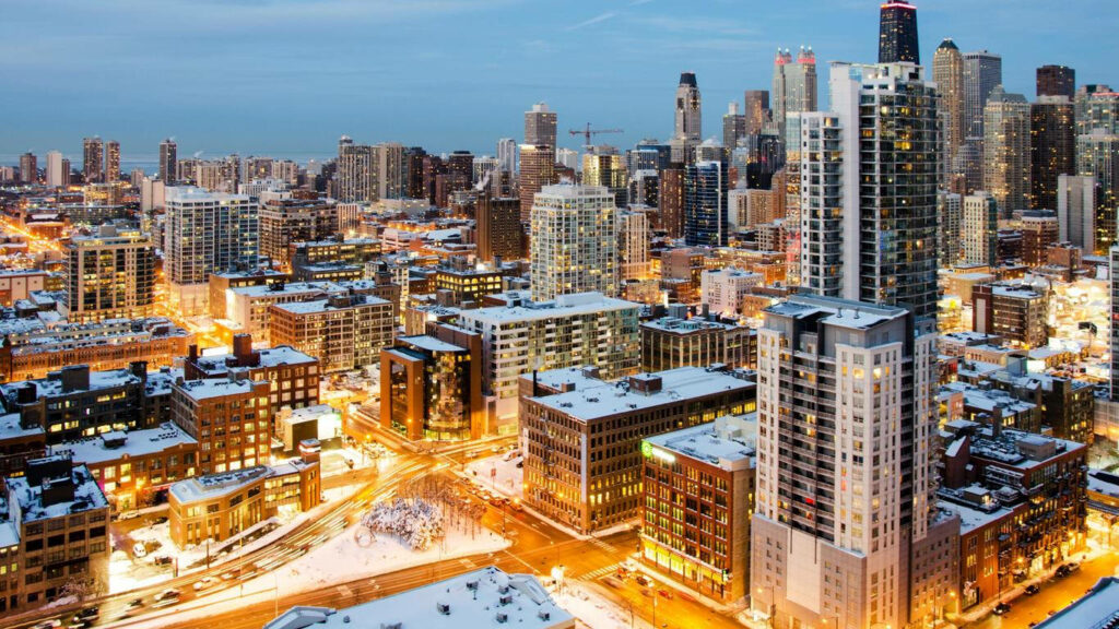 Winter Cityscape of Chicago: Snowy Rooftops & Illuminated Skyscrapers Wallpaper