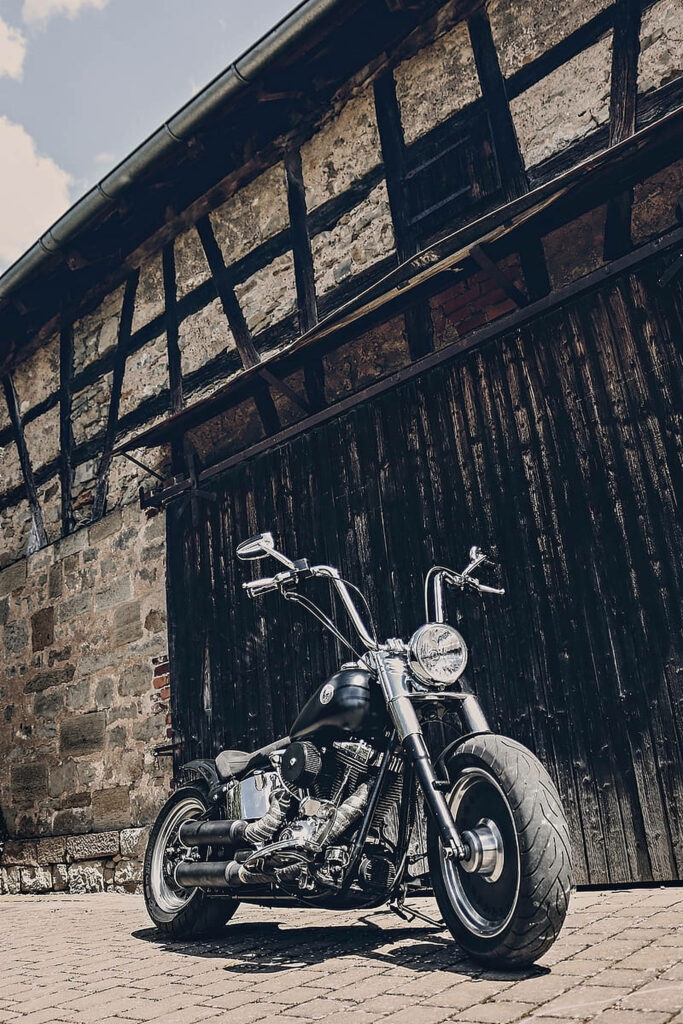 Low-Angle Chopper Motorcycle Wallpaper with Rustic Barn Backdrop