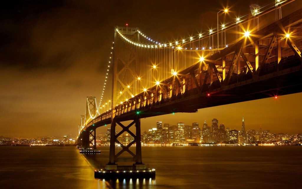 Vibrant City Bridge Wallpaper: Illuminated Night View & Reflective Water