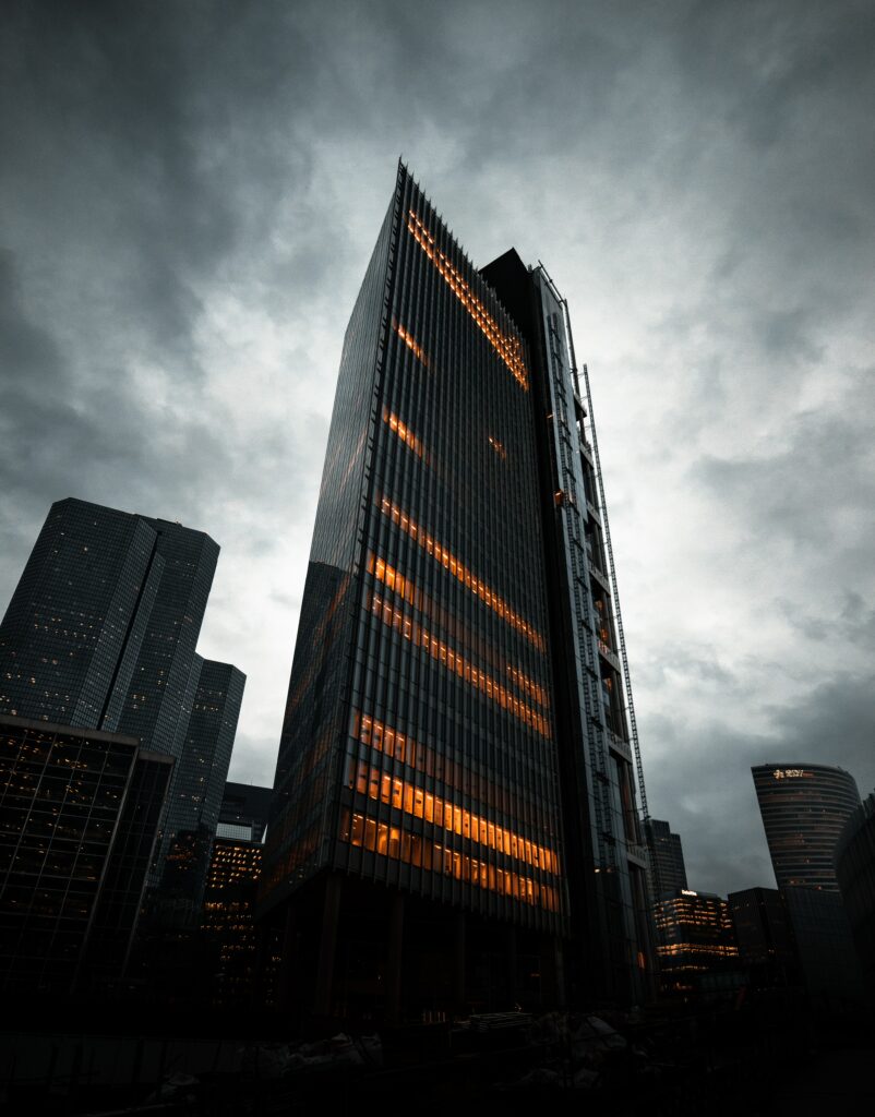 City Building Wallpaper: Dramatic Bottom-Up View with Warm Glow
