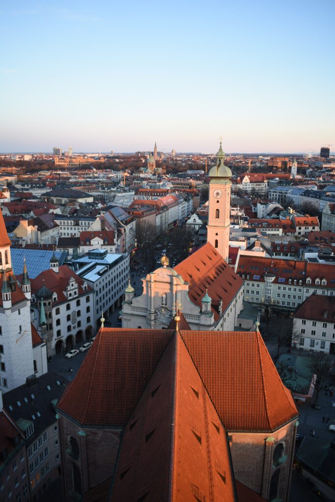Historic Town Cityscape: Vibrant Sunset & Charming Red-Roofed Architecture Wallpaper