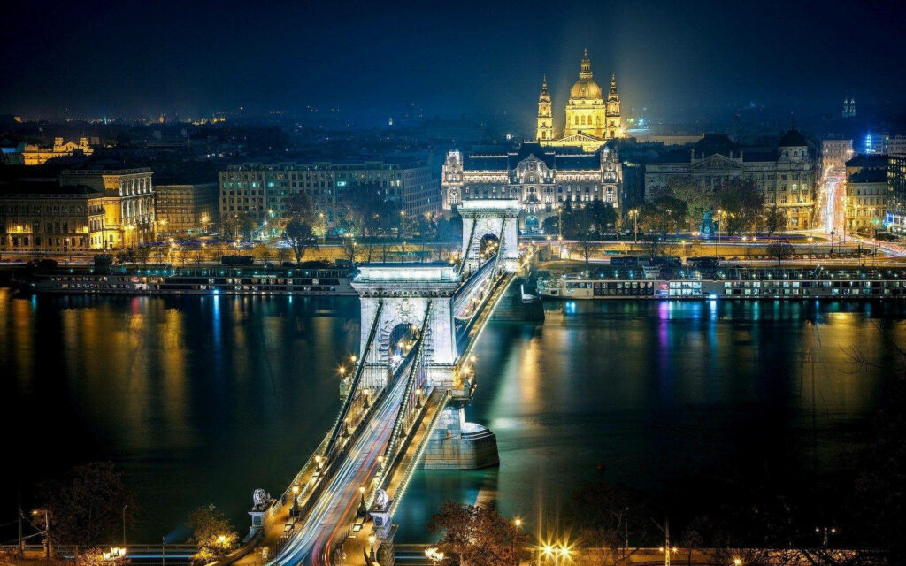 Majestic Cityscape Night View with Bridge and Historic Architecture Wallpaper