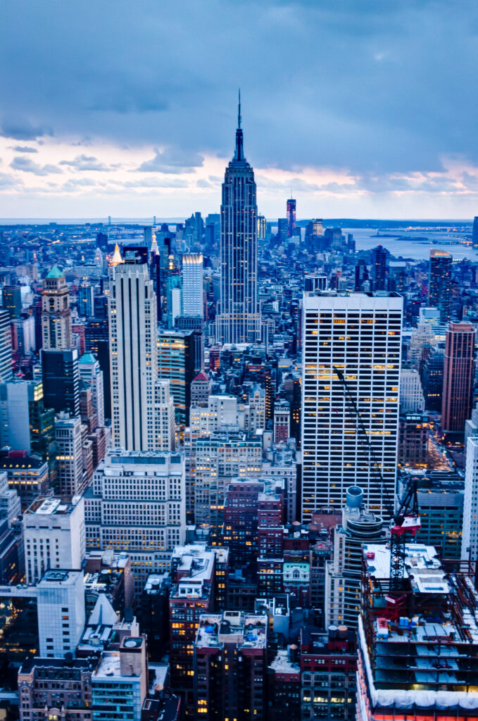 Stunning Evening Cityscape Wallpaper: Iconic Skyscrapers & Dramatic Sky