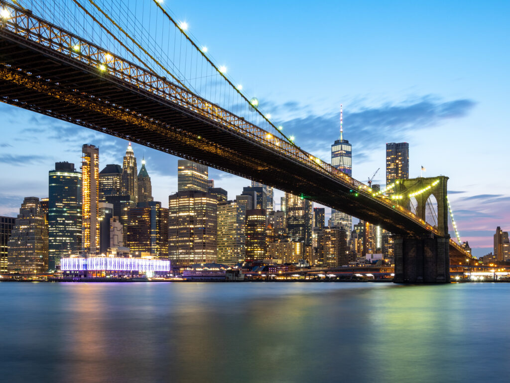 Twilight Cityscape Wallpaper: Illuminated Bridge Over Calm Waters