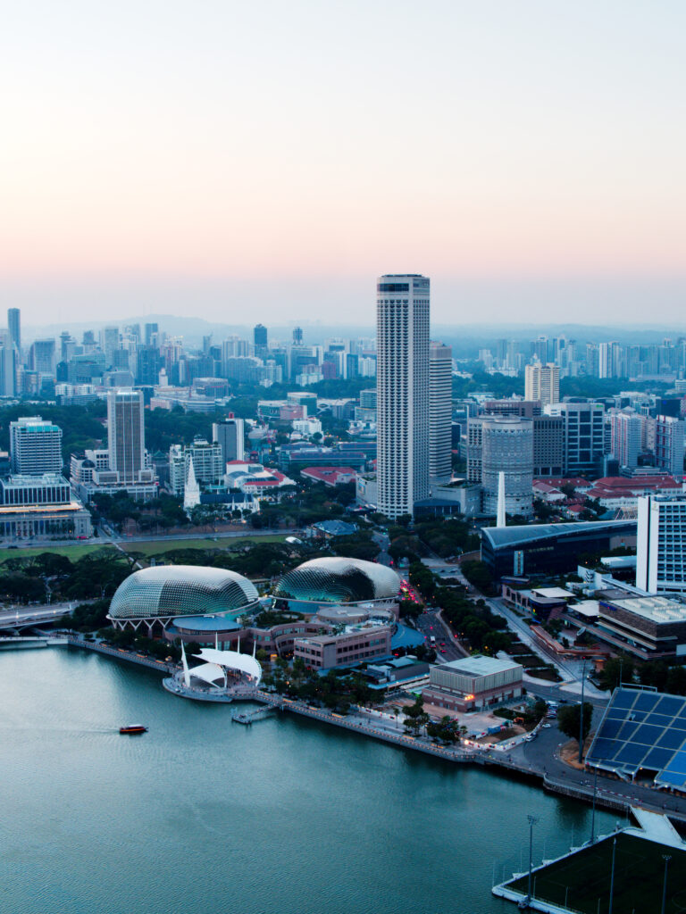 Stunning Cityscape Wallpaper: Modern Architecture Meets Serene Waterfront
