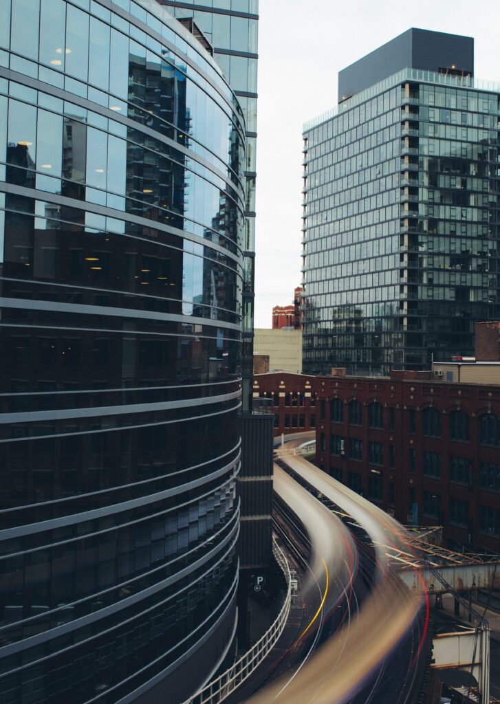 Vibrant Cityscape Wallpaper: Modern Buildings & Dynamic Traffic Trails