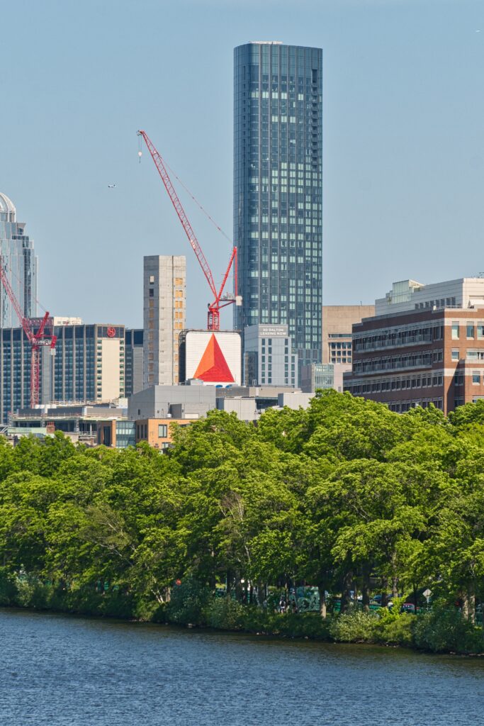 Stunning Cityscape Wallpaper: Skyscraper, Cranes & Lush Nature