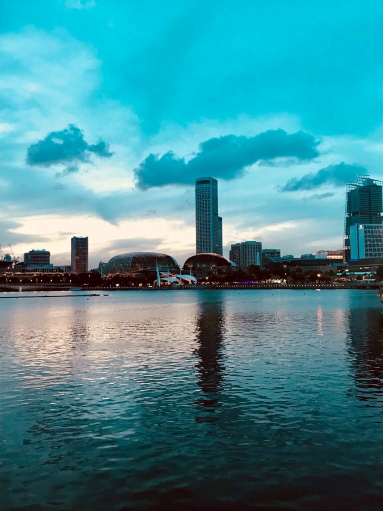 Serene Cityscape Wallpaper: Skyscrapers Reflected on Calm Water