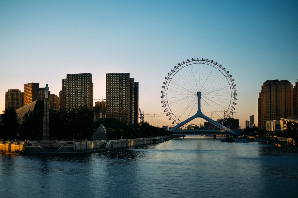 Cityscape Sunset Wallpaper: Ferris Wheel & Urban Reflections