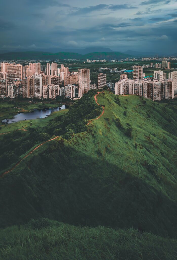 Stunning Cityscape Wallpaper: Urban High-Rises Meet Lush Hills