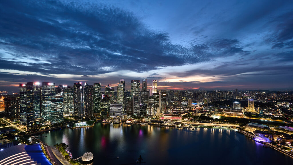 Vibrant Cityscape Wallpaper: Illuminated Skyline & Reflective Lake