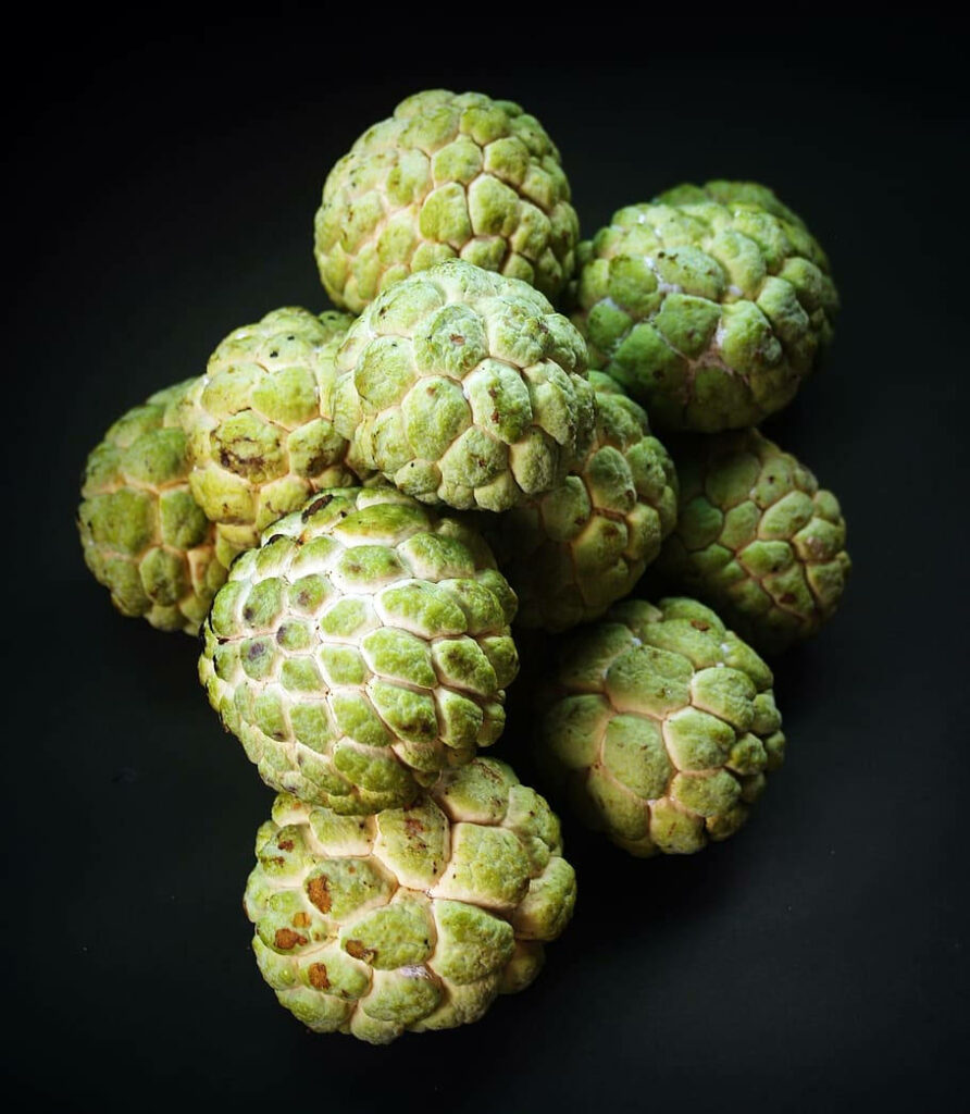 Stunning Close-Up of Fresh Sugar Apples on Dark Wallpaper Background