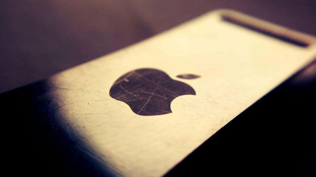 Macro Close-Up of Metallic Apple Logo | Sleek Textured Wallpaper