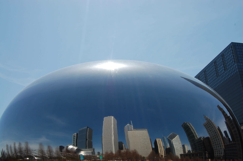 Close-Up Wallpaper of Cloud Gate in Chicago with Skyline Reflection