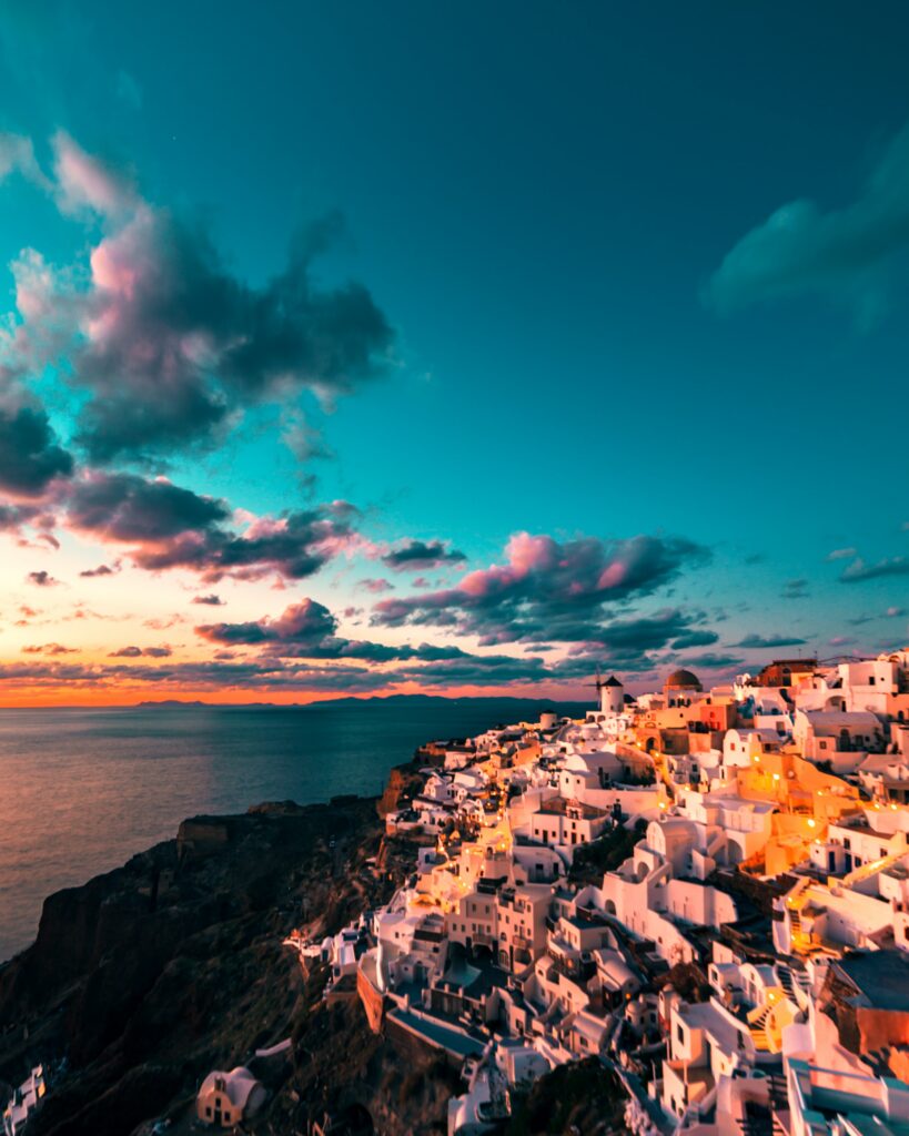 Coastal Cityscape Sunset Wallpaper: Vibrant Cliffs & Tranquil Sea