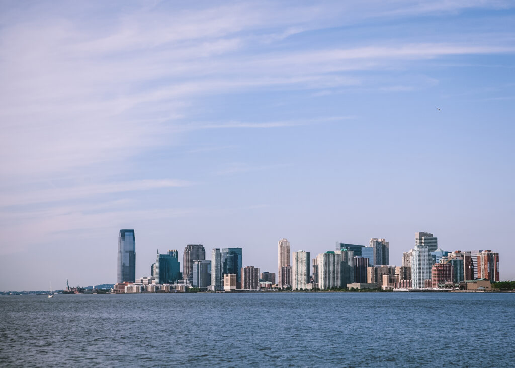 Stunning Coastal Cityscape Wallpaper: Modern Waterfront & Clear Sky