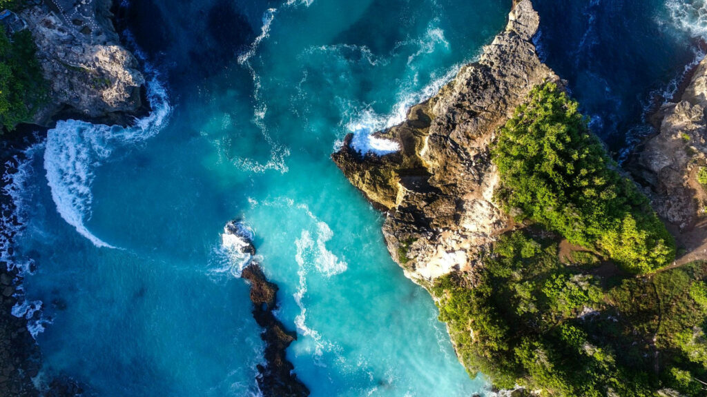 Stunning Aerial Wallpaper: Turquoise Ocean & Rugged Cliffs Background