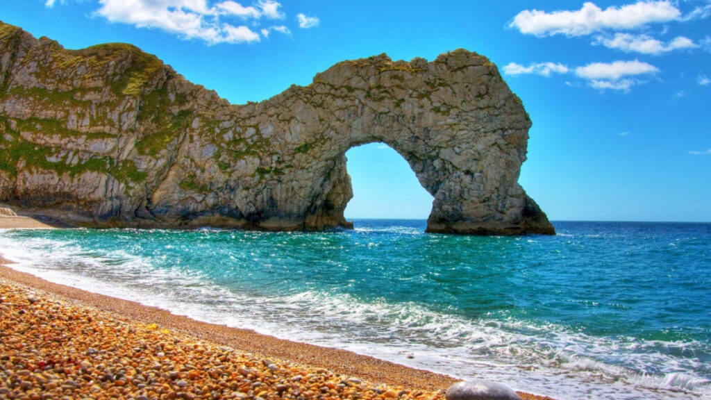 Coastal Serenity: Turquoise Waters and Rock Archway Wallpaper