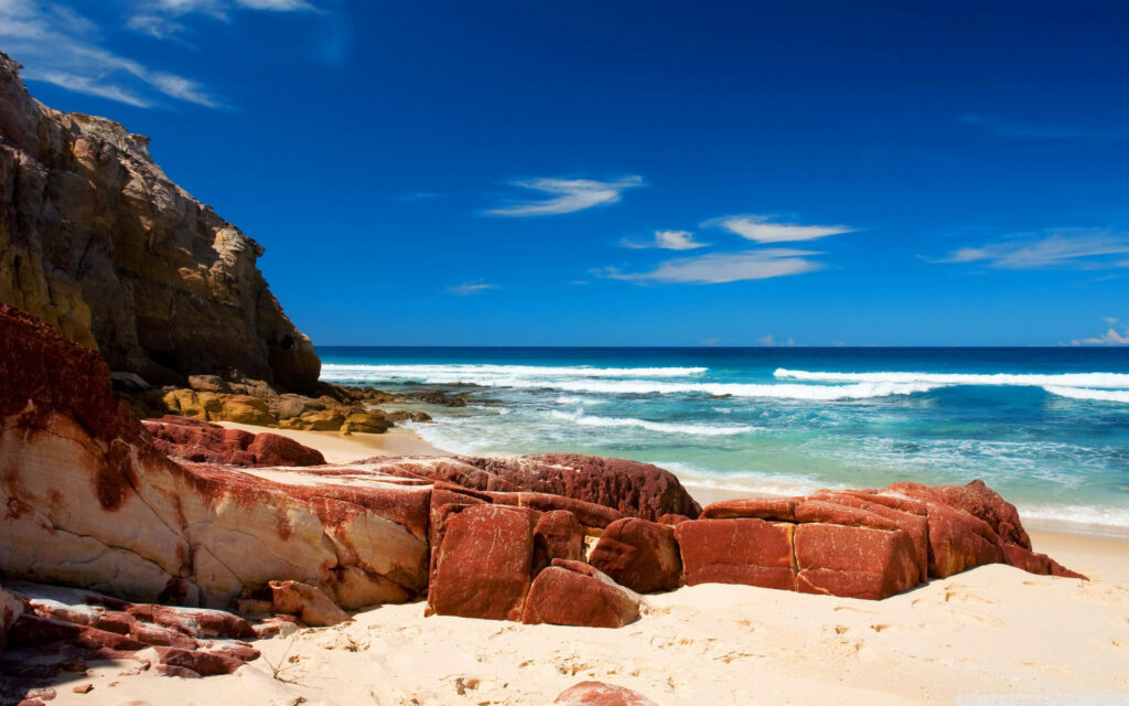 Coastal Wallpaper: Vibrant Red Rocks & Tranquil Ocean Scene