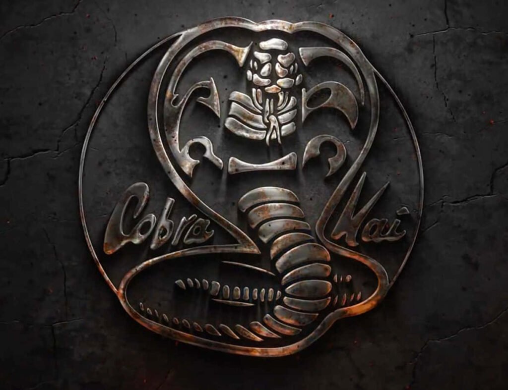 Metallic Cobra Kai Wallpaper: Iconic Logo on Dark Textured Background