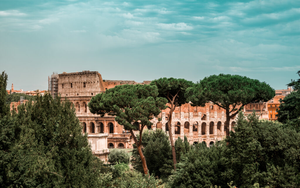 Colosseum Wallpaper: Iconic Rome Landmark Amidst Lush Greenery