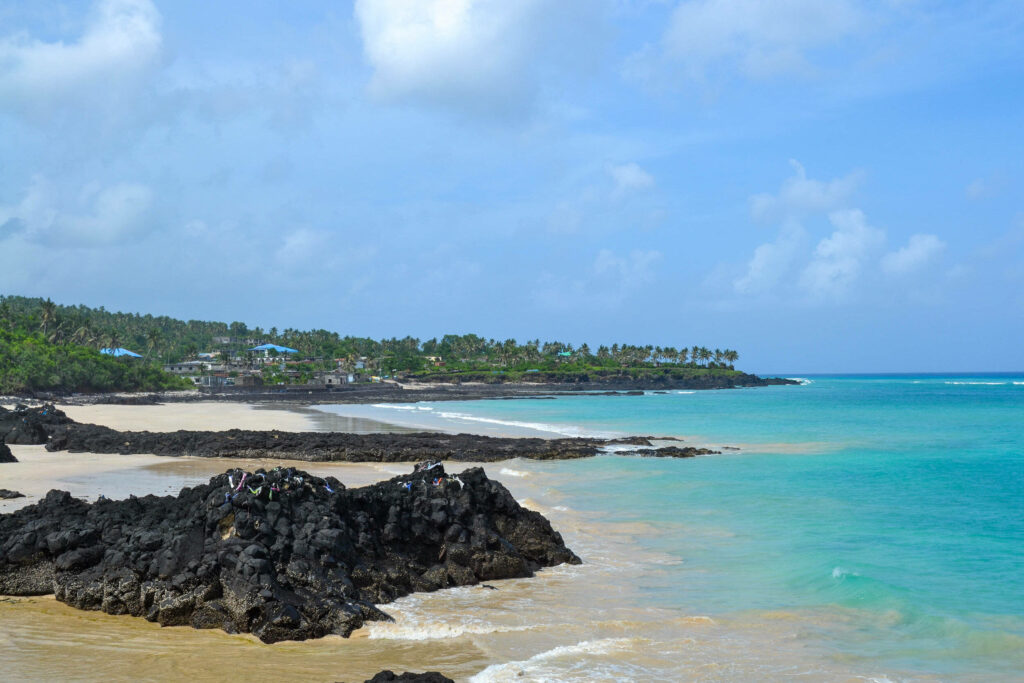 Stunning Comoros Beach Wallpaper: Turquoise Waters & Volcanic Rocks
