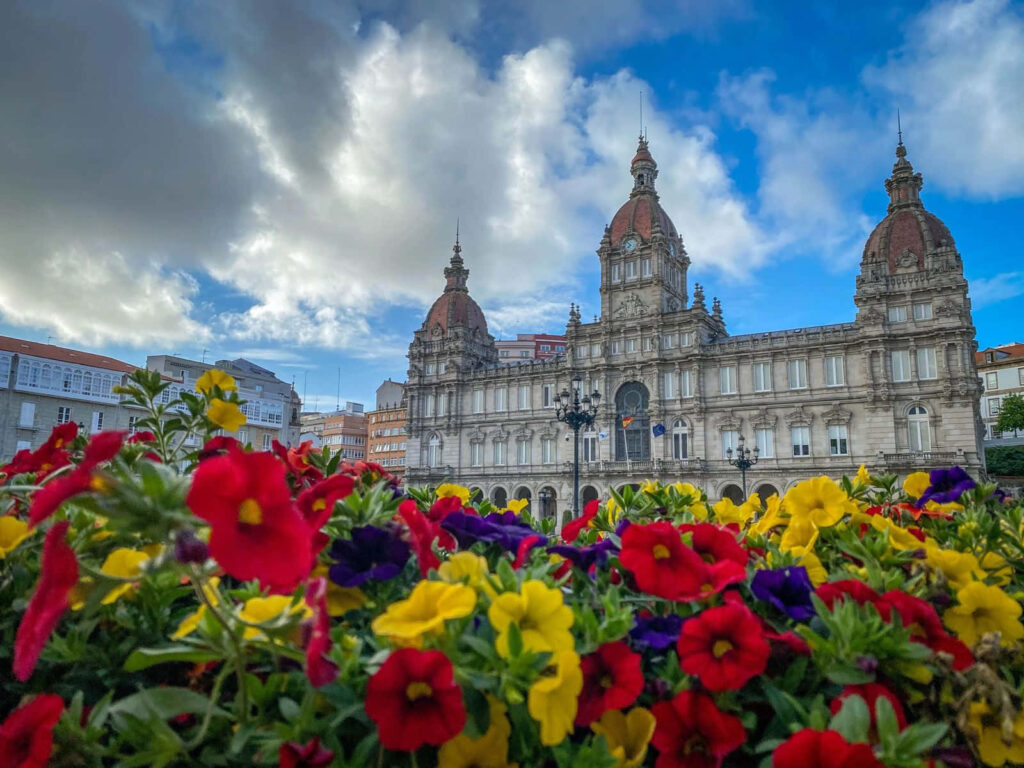 Stunning Corunna Wallpaper: Historic Architecture & Colorful Flowers