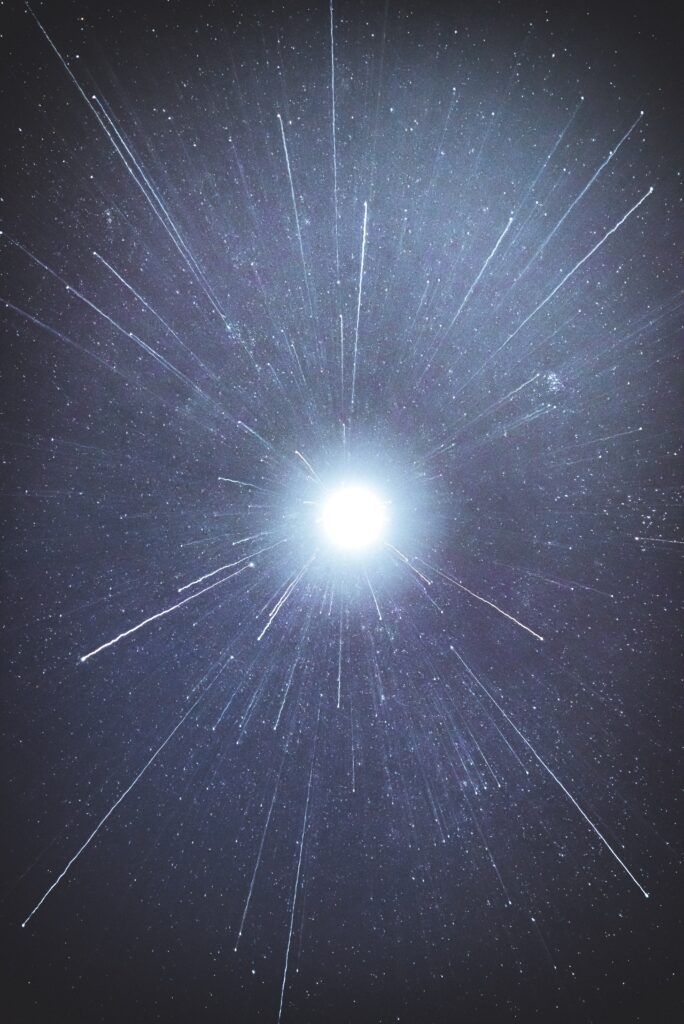 Stunning Cosmic Explosion Wallpaper: Radiant Light & Sparks Background